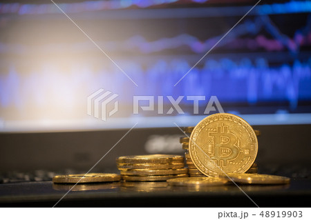 Bitcoin gold coin and defocused chart background. Bitcoin gold coin and defocused chart background. 48919903
