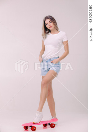 beautiful woman in white t-shirt with pink skateboard beautiful woman in white t-shirt with pink skateboard 48920160