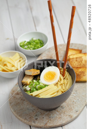 Egg noodle soup with bamboo shoots, tofu, and nori Egg noodle soup with bamboo shoots, tofu, and nori 48920716