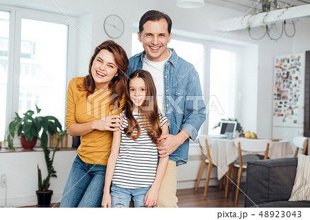 Happy family staying together in living room 48923043