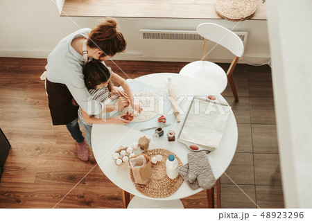 Mother and daughter making cookies at home 48923296