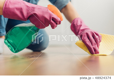 Woman trying to clean floor surface at home 48924374