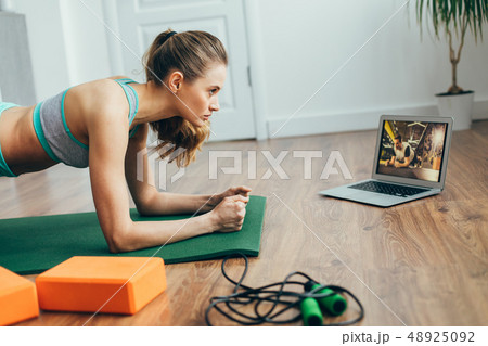 Young lady doing plank practice at home Young lady doing plank practice at home 48925092