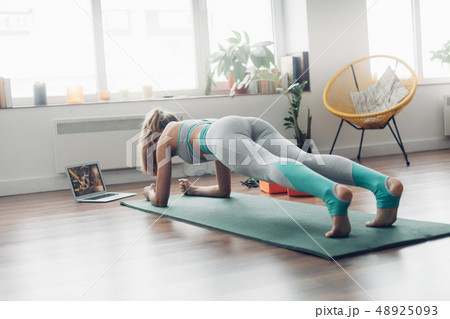 Young lady doing plank aerobics practice at home Young lady doing plank aerobics practice at home 48925093