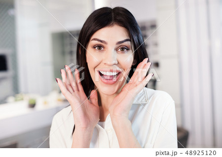 Portrait of excited woman with beautiful makeup situating in barber shop Portrait of excited woman with beautiful makeup situating in barber shop 48925120