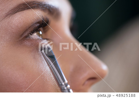 ropped photo of attractive young woman applying eyeshadows ropped photo of attractive young woman applying eyeshadows 48925188