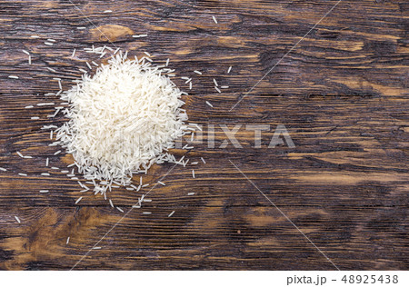 Heap of rice on wooden table, top view. Heap of rice on wooden table, top view. 48925438