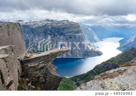 Couple of tourists on Trolltunga in Norway 48926983