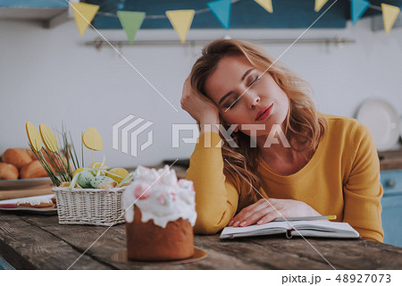 Tired woman napping with copybook on kitchen 48927073