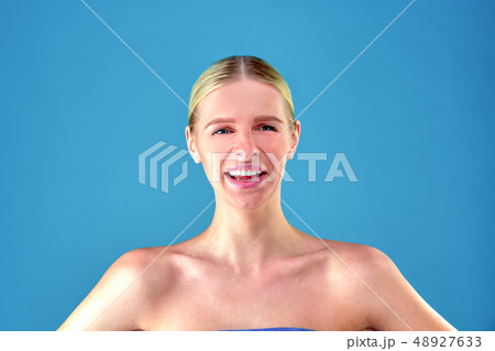 Perfect blonde girl, young blonde girl at blue background. Close up portrait. Skin care concept Perfect blonde girl, young blonde girl at blue background. Close up portrait. Skin care concept 48927633