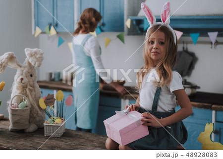 Little girl going to look into present box Little girl going to look into present box 48928083