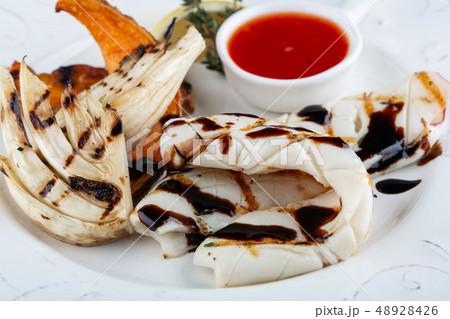Kalmar fried on a grill in soy sauce moves with  48928426