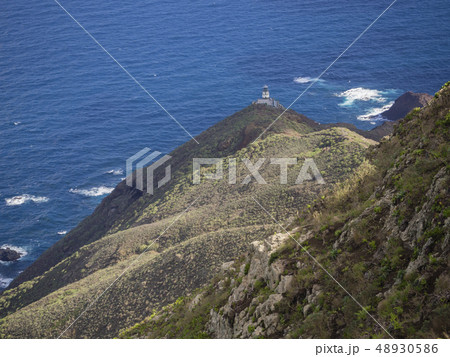 view on Faro de Anaga lighthouse with green hills blue sea atlantic ocean scenery in anaga mountain view on Faro de Anaga lighthouse with green hills blue sea atlantic ocean scenery in anaga mountain 48930586