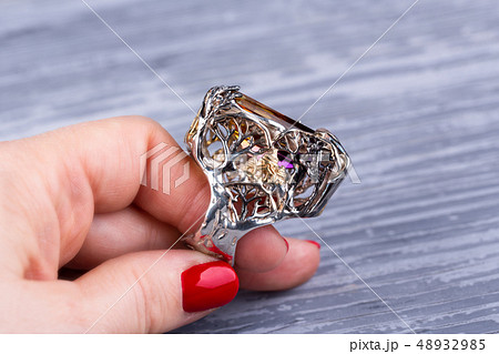 A silver ring with ametriny in a frame 48932985