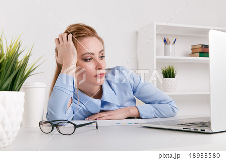 Portrait of tired office woman working by computer. Laptop problem. Portrait of tired office woman working by computer. Laptop problem. 48933580