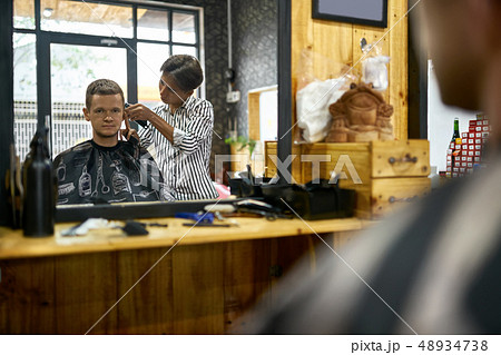 Man is cutting his hair in asian barbershop Man is cutting his hair in asian barbershop 48934738