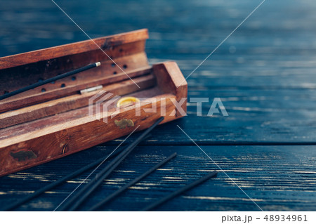 sandalwood sticks on a black wooden table.  sandalwood sticks on a black wooden table.  48934961