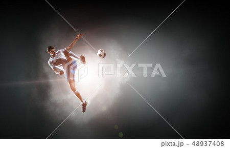 Soccer player hitting ball Soccer player hitting ball 48937408