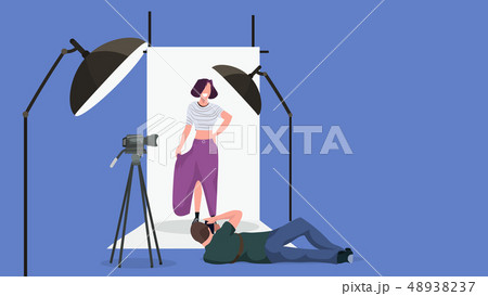 professional man photographer on lying pose shooting beautiful sexy woman model posing modern photo 48938237