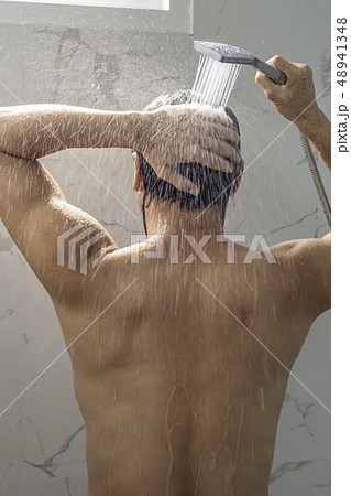 Asian man taking a shower in the bathroom. 48941348