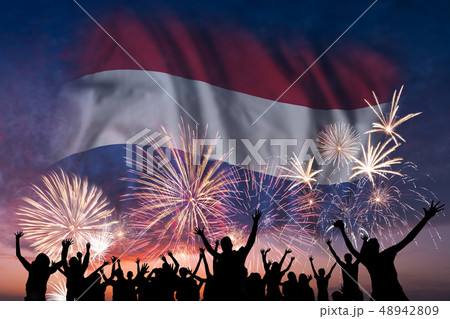 People are looking on fireworks and flag of People are looking on fireworks and flag of 48942809