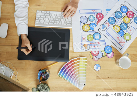 Graphic designer drawing icons for application Graphic designer drawing icons for application 48943925