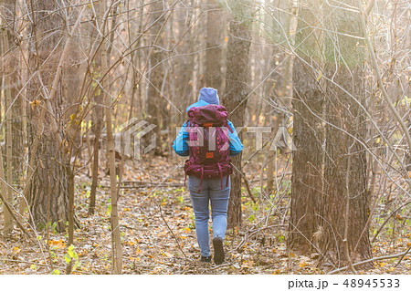 People and nature concept -Traveller woman walking in the forest, back view 48945533