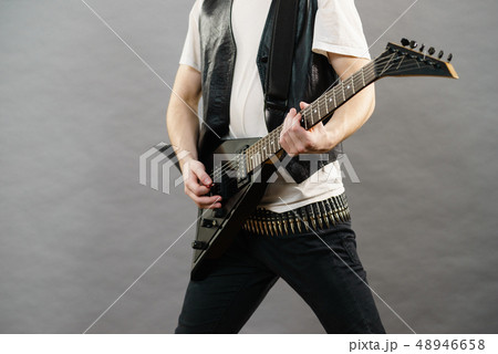 Male hands playing electric guitar Male hands playing electric guitar 48946658