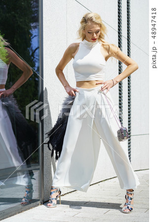 Woman wearing crop top and culottes Woman wearing crop top and culottes 48947418