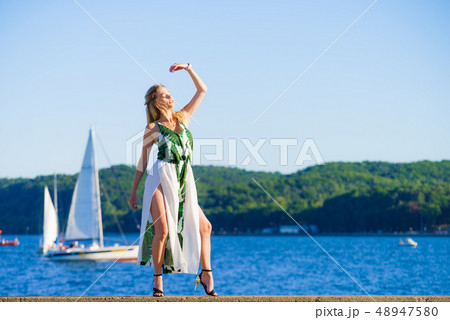 Woman in summer long dress against sea 48947580