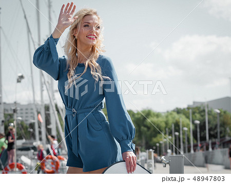 Fashion model wearing blue jumpsuit Fashion model wearing blue jumpsuit 48947803