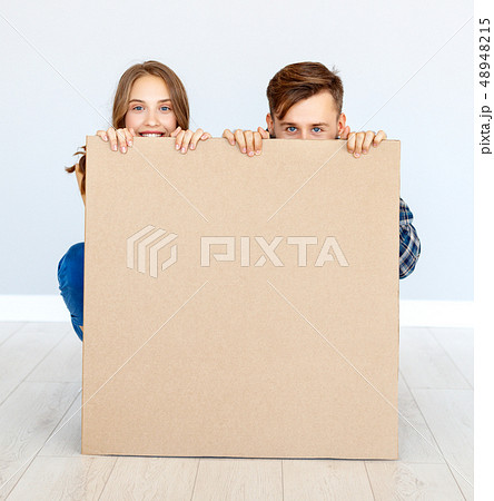 happy family couple with cardboard poster on blank happy family couple with cardboard poster on blank 48948215