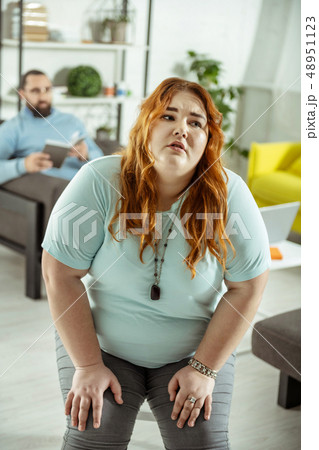Emotional red-haired overweight girl having eating disorder Emotional red-haired overweight girl having eating disorder 48951123