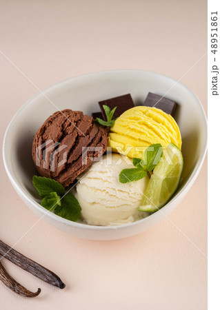 Trio of tasty chocolate vanilla and lime flavored frozen dessert in a white bowl. Trio of tasty chocolate vanilla and lime flavored frozen dessert in a white bowl. 48951861