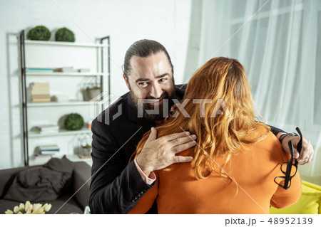 Positive delighted man caressing his plus size girlfriend Positive delighted man caressing his plus size girlfriend 48952139