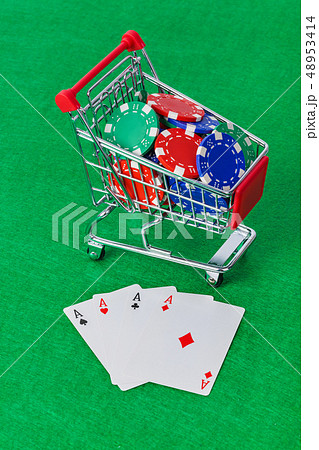 Casino chips in shopping cart on green table Casino chips in shopping cart on green table 48953414