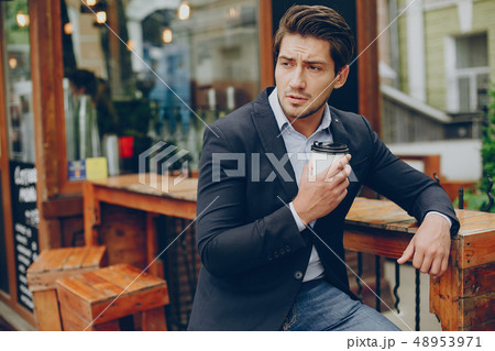 Handsome businesman in a summer city 48953971