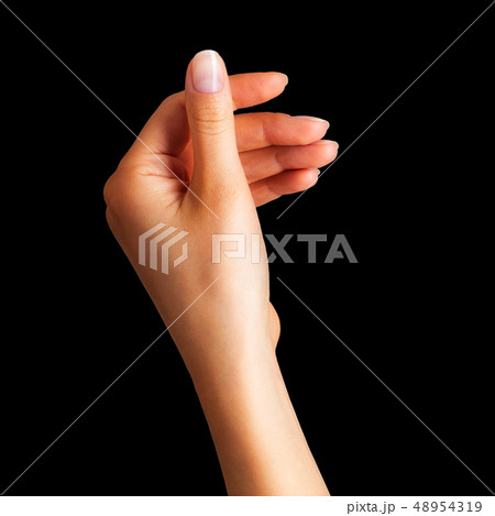 Woman hand holding something with two fingers Woman hand holding something with two fingers 48954319
