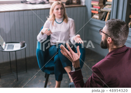 Top view of man having family problems talking to professional therapist Top view of man having family problems talking to professional therapist 48954320
