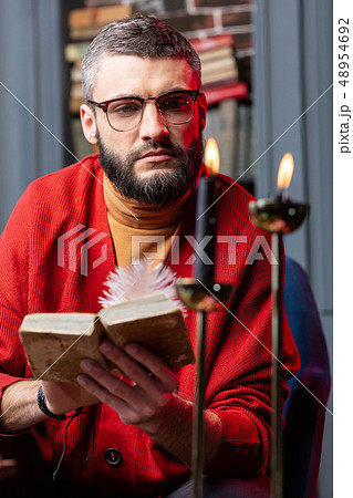 Bearded fortune-teller feeling inspired while reading old book Bearded fortune-teller feeling inspired while reading old book 48954692