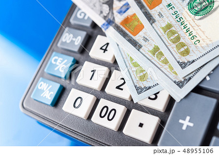 Business and financial background with dollars and calculator. Bookkeeping background. 48955106