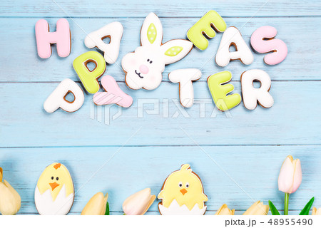 Delicious Easter cookies background. Eggs with different pattern icing on blue wooden background 48955490