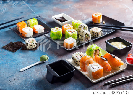 Traditional Japanese food- sushi, rolls, chopsticks, soy sauce on color stone background. Sushi menu Traditional Japanese food- sushi, rolls, chopsticks, soy sauce on color stone background. Sushi menu 48955535