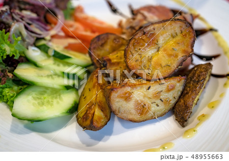 Roast potatoes with rosemary and salad 48955663