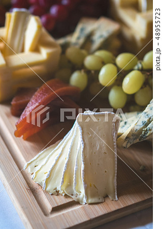 Cheese platter on a wooden desk 48955723