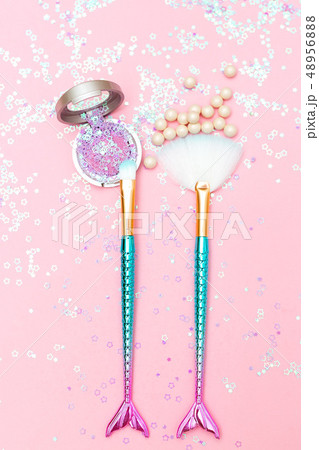 Makeup brush and eyeshadow on pink glitter 48956888