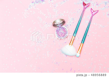 Makeup brush and eyeshadow on pink glitter Makeup brush and eyeshadow on pink glitter 48956889