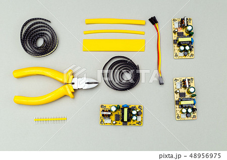 Yellow  electronic device on gray background.  48956975
