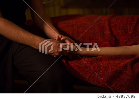 Masseur doing hand massage for female client 48957698