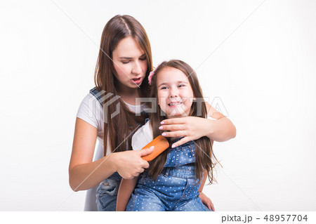 Family, motherhood and parent concept - mother combing her little daughter's hair isolated on white 48957704